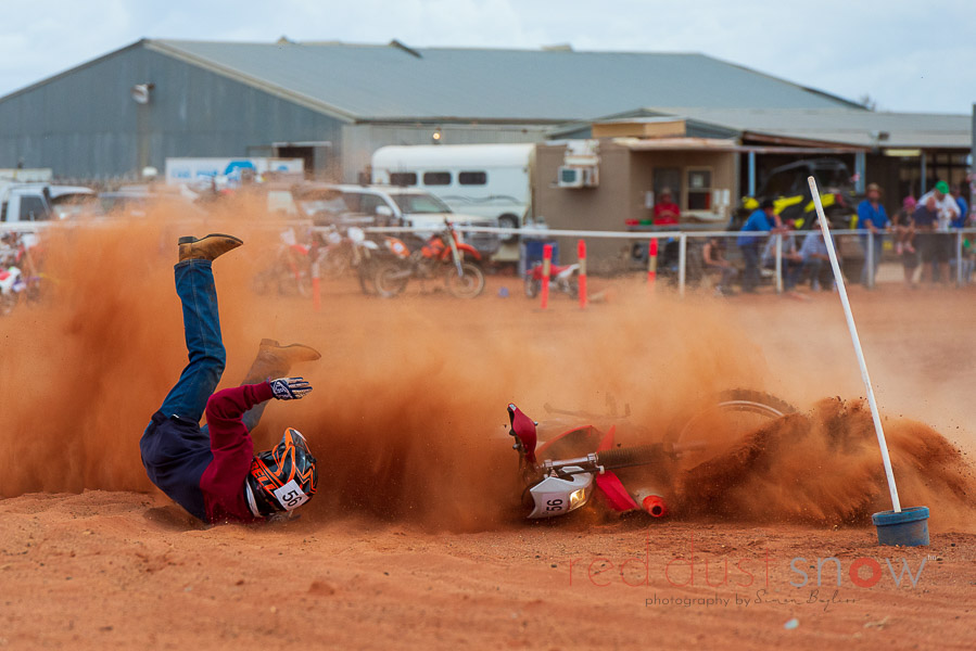 A Lucky escape for a motorbike rider at the Packsaddle Bikehana, as he falls off in the thick bulldust as he tried to round a sharp corner. Packsaddle, Outback NSW, Australia